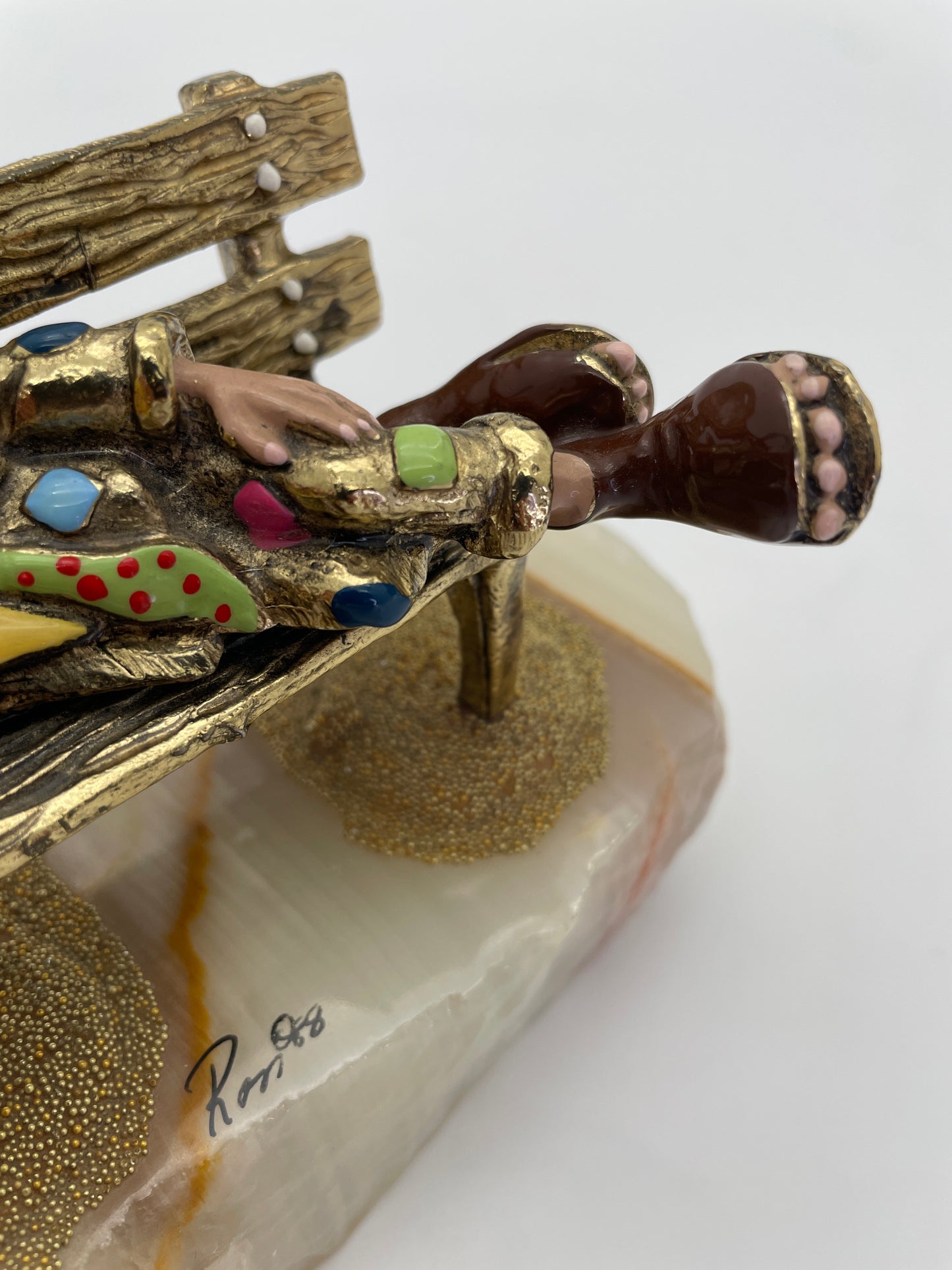 Close-up detail of the oversized clown shoes, colorful costume, natural onyx base, and Ron ’88 signature on a vintage Ron Lee sculpture.