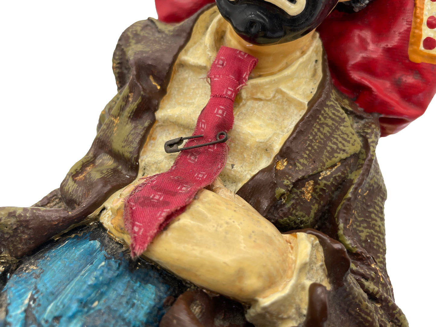 Close-up of the hand-painted clothing, necktie, and sculpted details on a signed Ron Lee hobo clown sculpture.