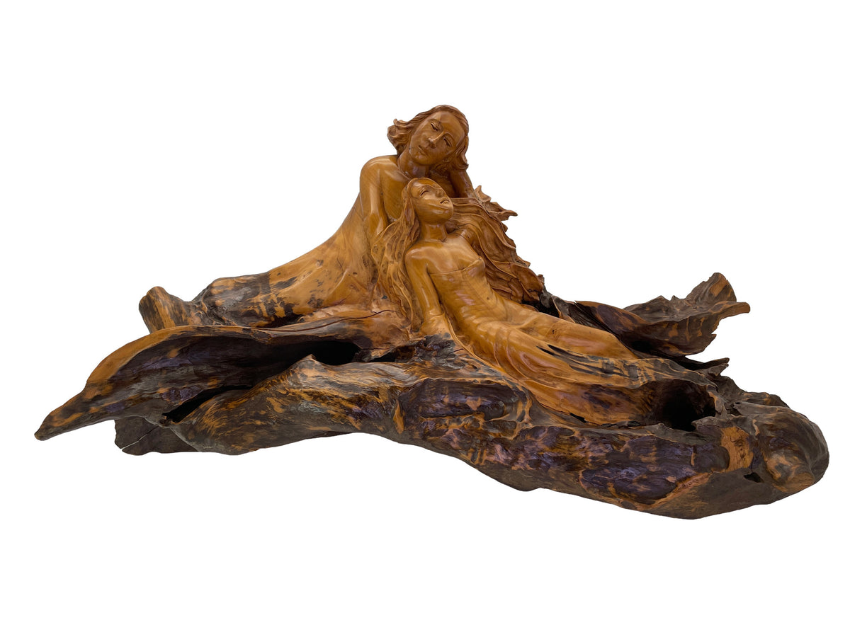Wide profile of large mahogany figurative sculpture with two women