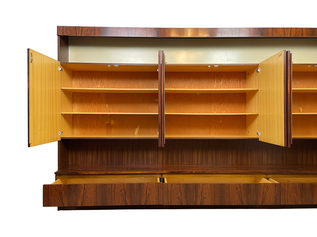 Front detail showing three open storage compartments with adjustable shelves and open lower drawers.