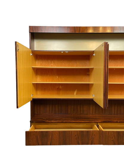 Detail of the left cabinet with two adjustable shelves, light-wood interior, and lower drawer open.