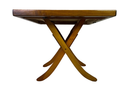 Low side view showing the marquetry tabletop, crossed legs, and underframe construction.
