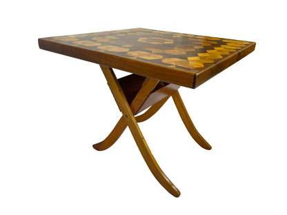 Low-angle view emphasizing the folding table's crossed legs and gently upturned curved feet.