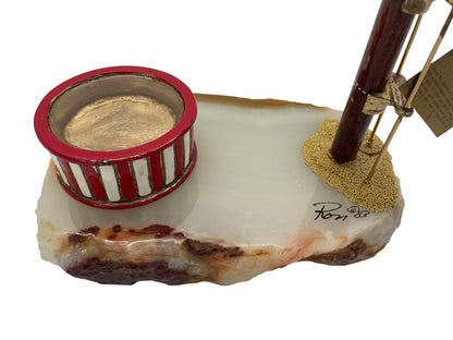 Close-up of the natural onyx base with stylized circus pool, artist signature dated 1983, and gold-plated details.