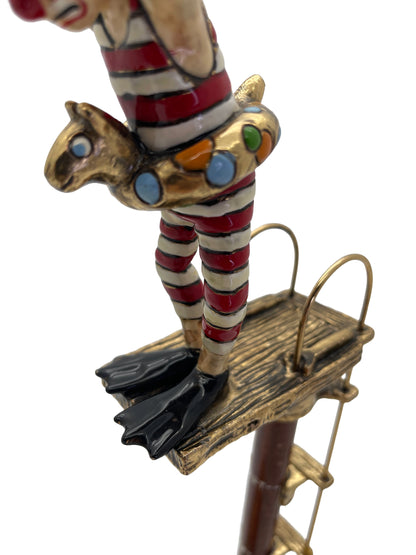Detail of the colorful 24K gold-plated animal-shaped swim ring on Ronald A. Lee’s clown high diver sculpture.