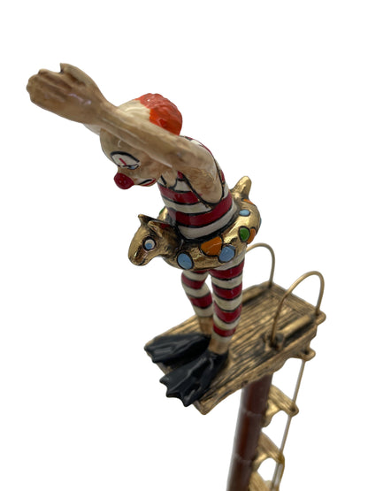 Overhead angle highlighting the diving pose, platform, colorful float, and hand-painted details of the Ronald A. Lee sculpture.