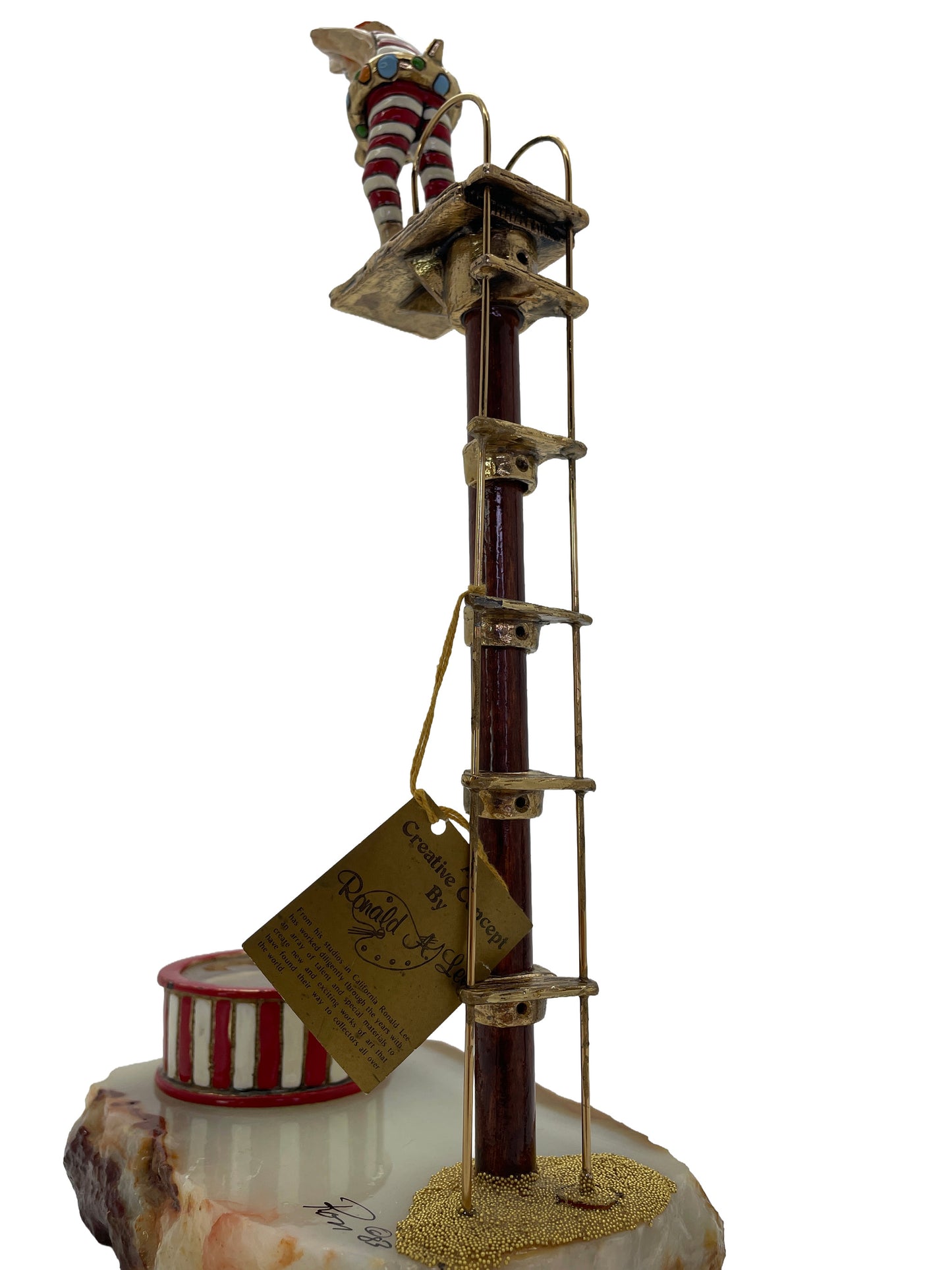 Rear three-quarter view of Ronald A. Lee’s hand-painted clown diving platform sculpture showing the original artist label.