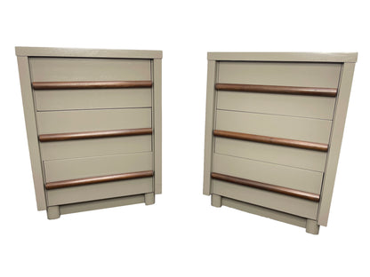Front view of a pair of restored American of Martinsville nightstands in chestnut gray lacquer with walnut drawer pulls and three drawers.