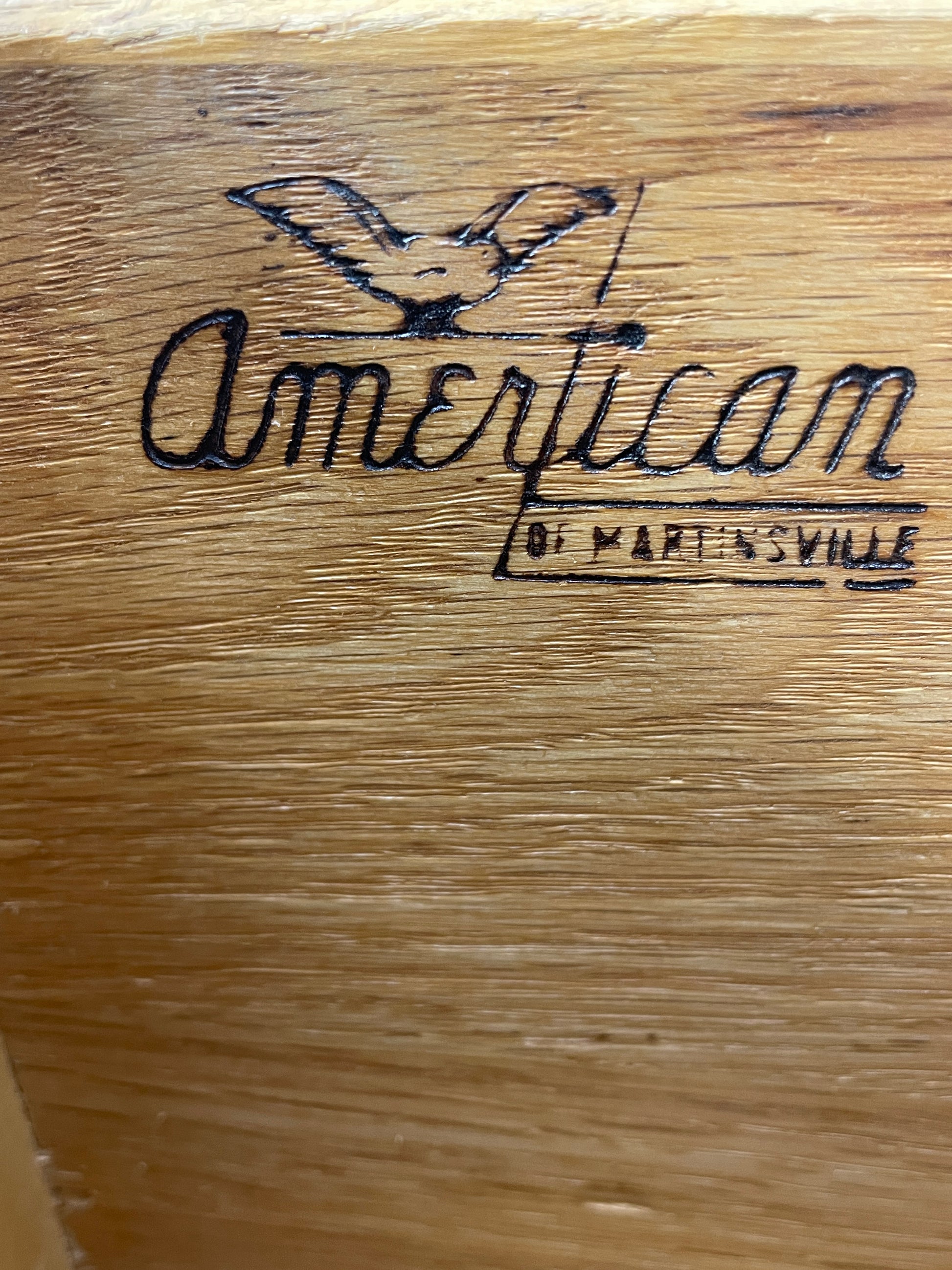 Close-up of the American of Martinsville manufacturer stamp inside a Mid-Century Modern nightstand drawer.