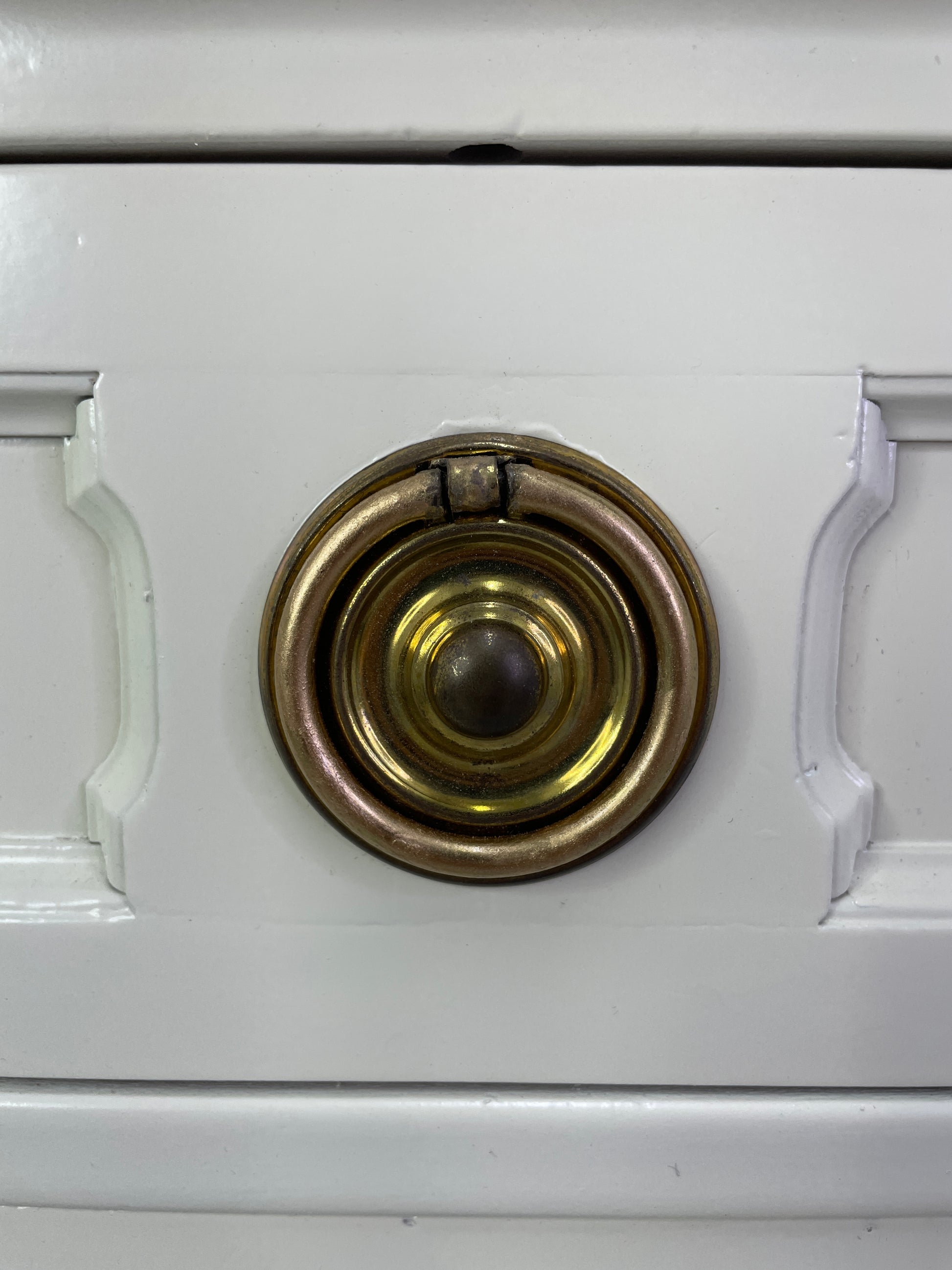Close-up of original brass hardware on American of Martinsville nightstand with light patina
