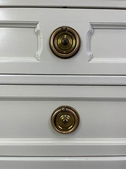 Close-up of original brass hardware on American of Martinsville nightstand with light patina drawers
