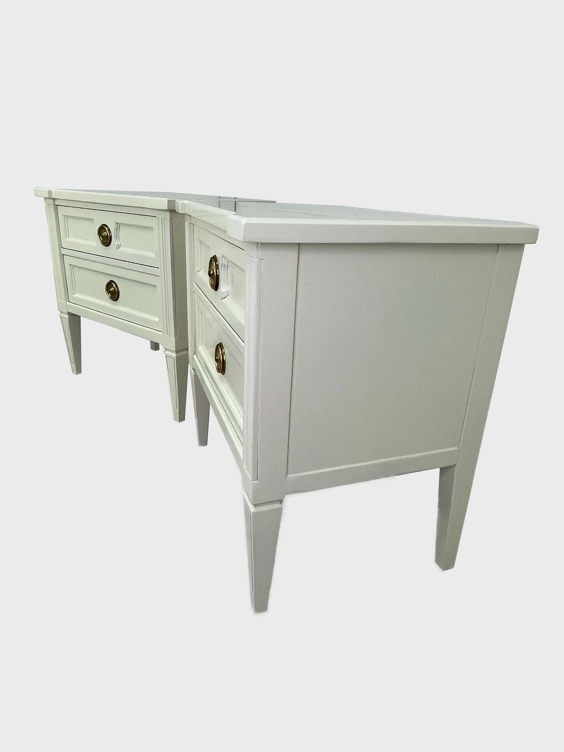 Side angle view of American of Martinsville nightstands with tapered legs and fluted detailing
