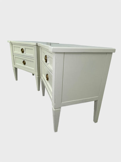 Side angle view of American of Martinsville nightstands with tapered legs and fluted detailing
