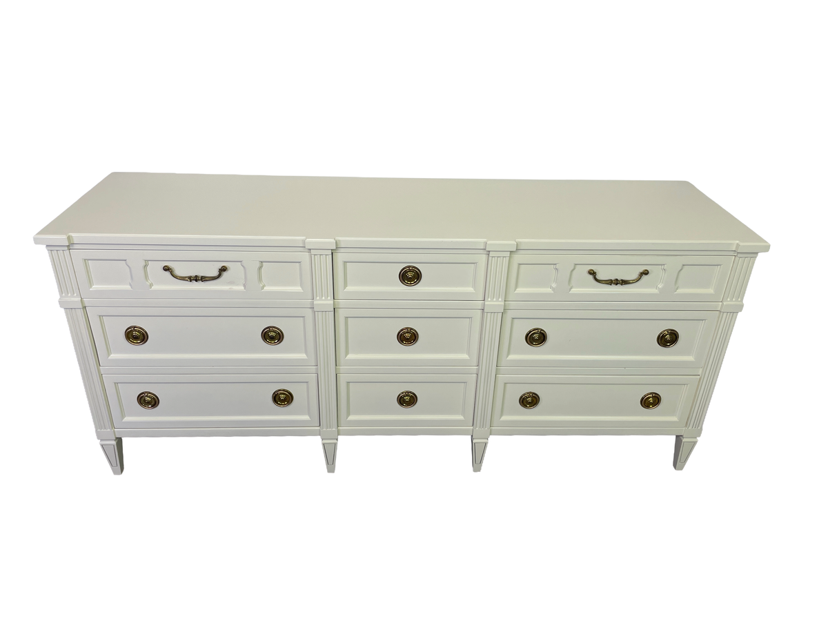 Elevated view of the warm off-white lacquered top and nine-drawer front of the American of Martinsville dresser