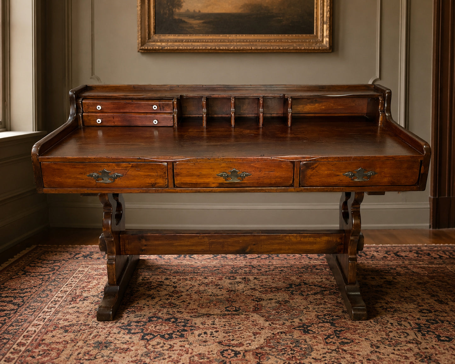 Antique Victorian writing desk in solid pine with hutch compartments, porcelain knobs, and trestle base, styled in an elegant historic interior with a Persian rug and warm natural light.
