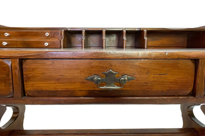 Close-up detail of original brass drawer pull on an early 20th century Victorian solid pine writing desk.
