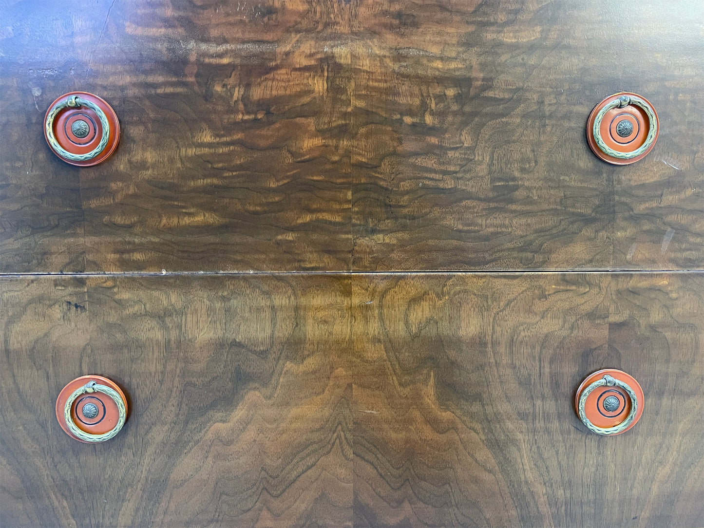 Close-up of drawer fronts showing rich walnut wood grain on vintage Sligh cabinet