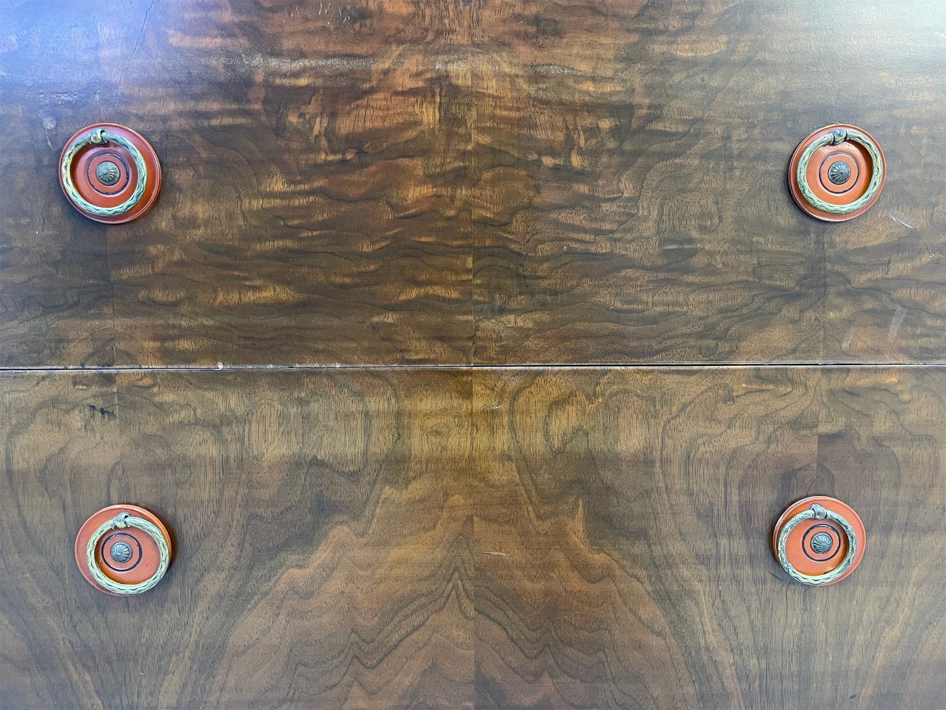 Close-up of drawer fronts showing rich walnut wood grain on vintage Sligh cabinet