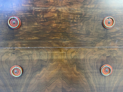 Close-up of drawer fronts showing rich walnut wood grain on vintage Sligh cabinet