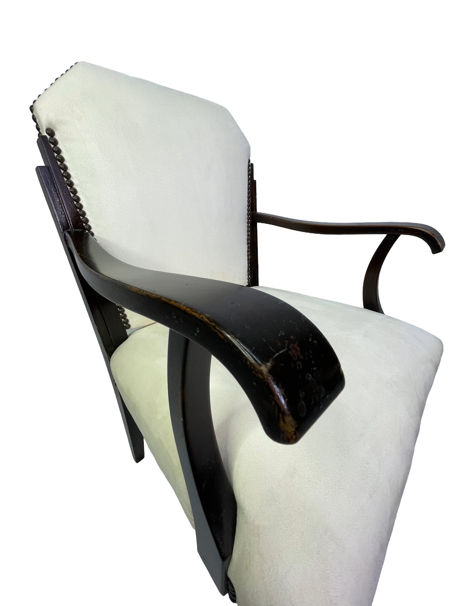 Close-up detail of curved mahogany armrest with vintage patina on an Art Deco style ivory upholstered dining armchair.