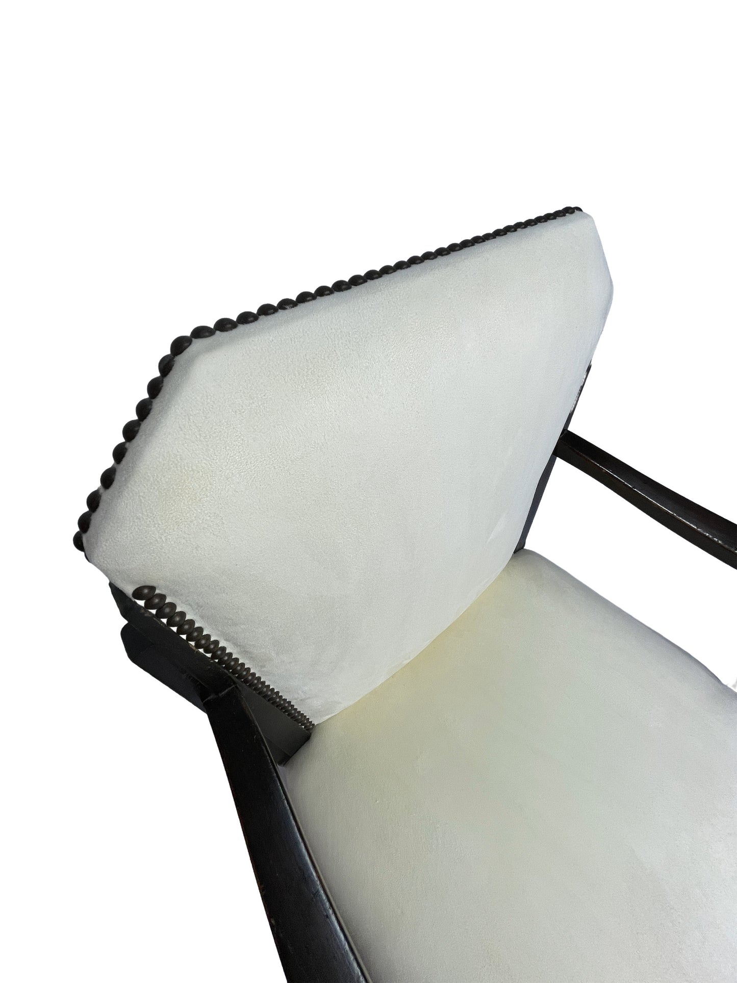 Close-up detail of ivory upholstered backrest with nailhead trim on a vintage Art Deco style dining chair with dark mahogany frame.