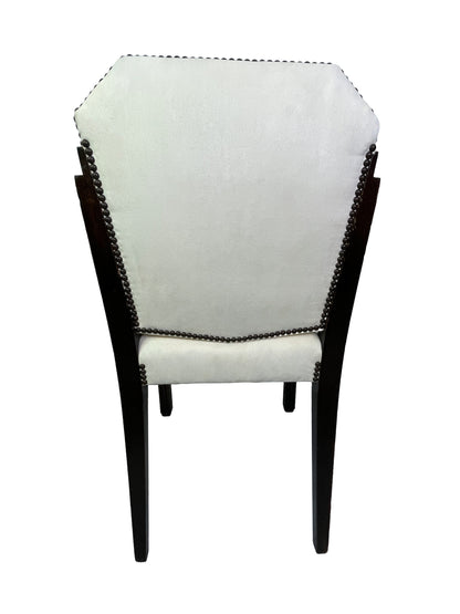 Rear view of a vintage Art Deco style side chair featuring ivory suede-like upholstery, decorative nailhead trim, and dark wood legs.