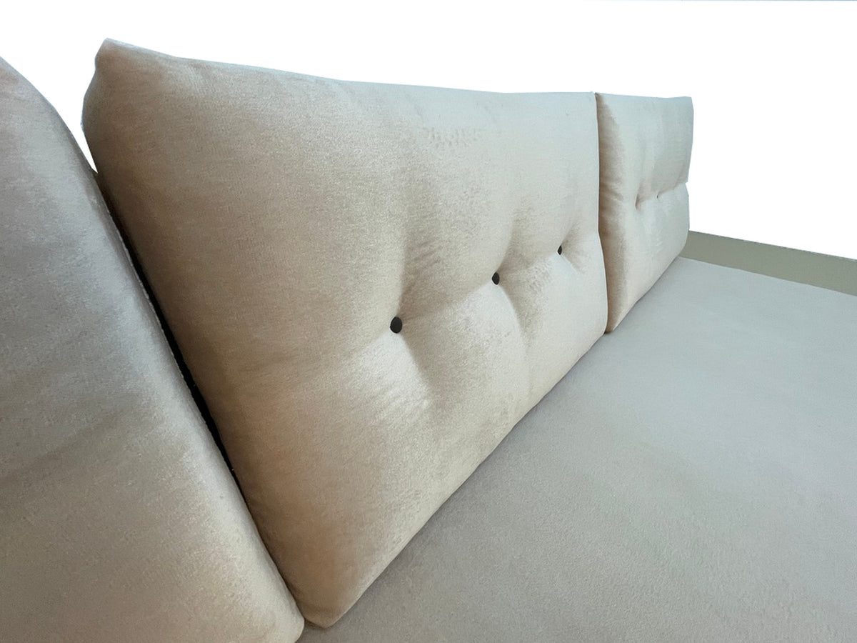 Close-up detail of blush velvet tufted back cushions on a custom convertible sofa.