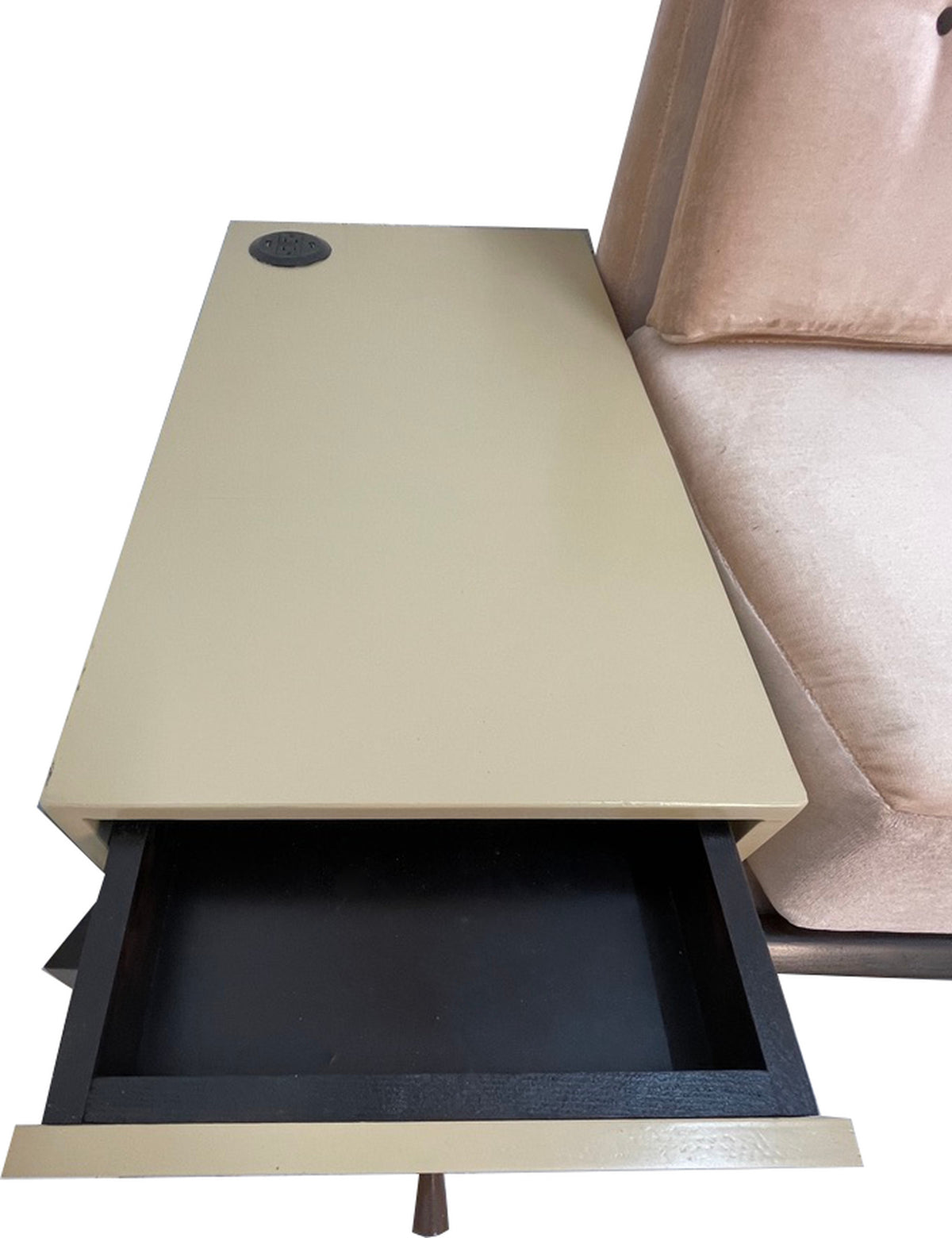Built-in side table featuring a power outlet and storage drawer attached to a custom convertible daybed sofa.