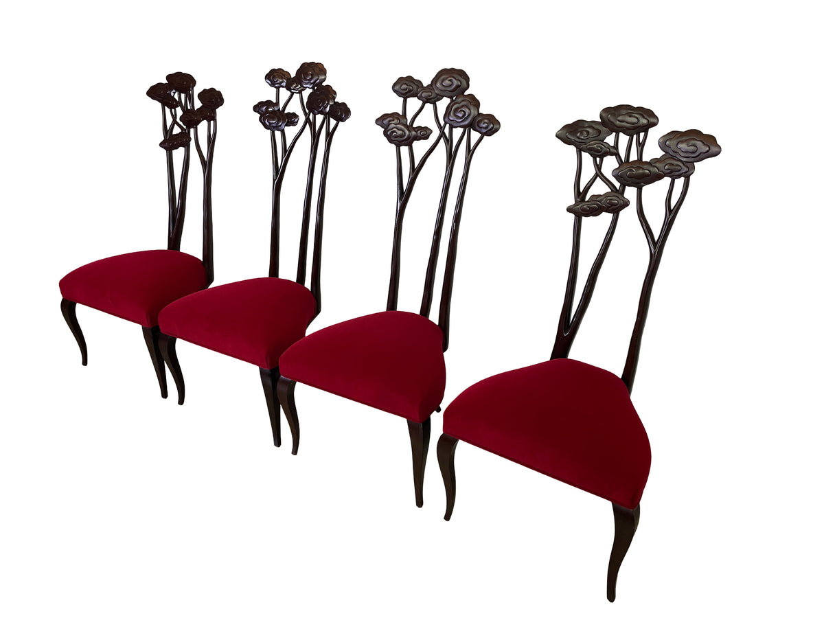 Angled view of four Le Jardin mahogany dining chairs with red velvet seats and complementary floral backs.