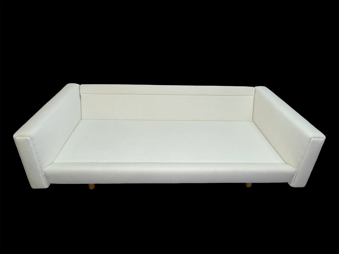 Custom contemporary white upholstered daybed with sculptural angled arms and low-profile lounge silhouette.