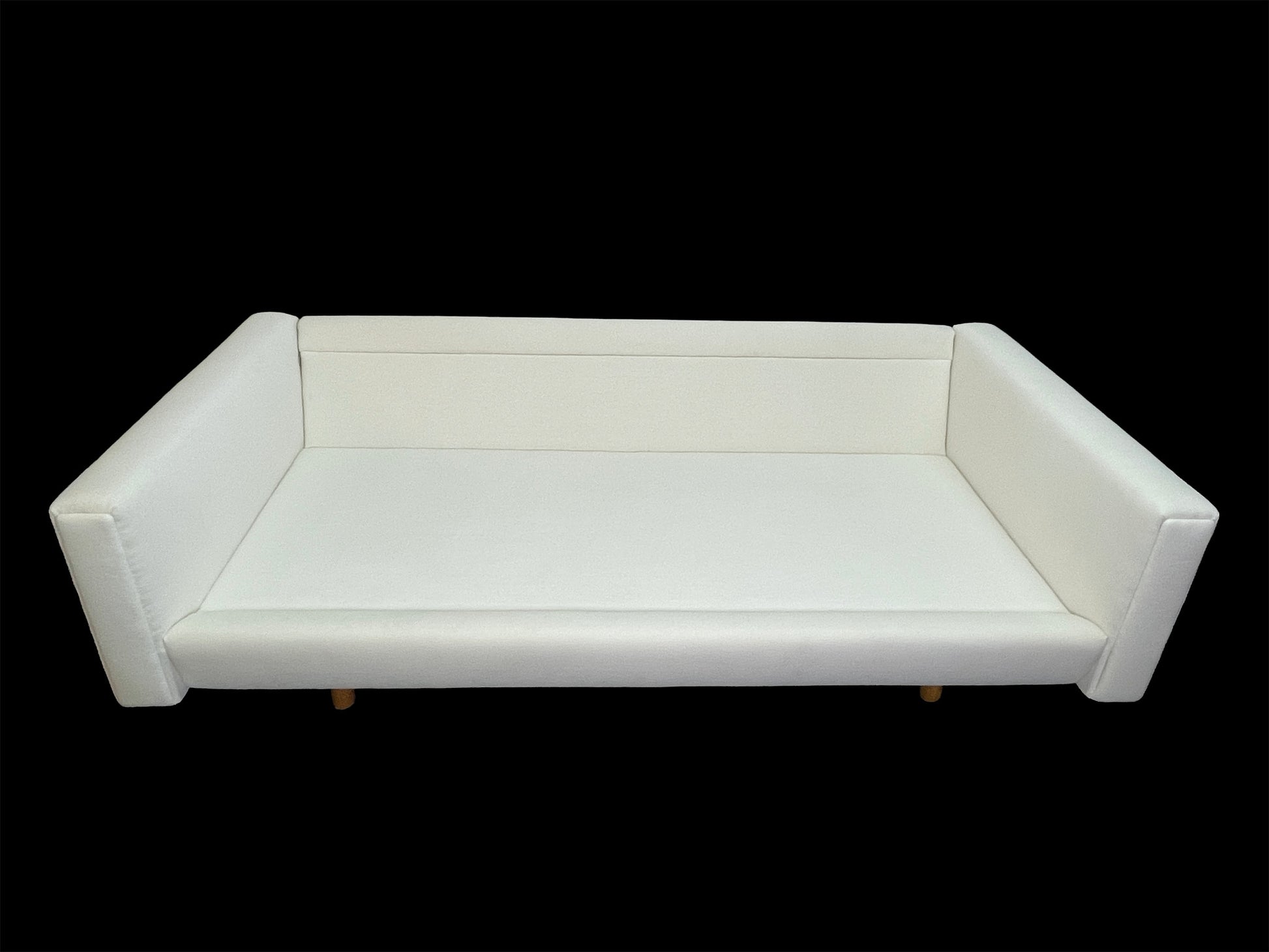 Custom contemporary white upholstered daybed with sculptural angled arms and low-profile lounge silhouette.