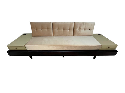 Custom convertible daybed sofa with integrated side tables, blush pink upholstery, built-in drawers, and dark wood base, circa 1990s.