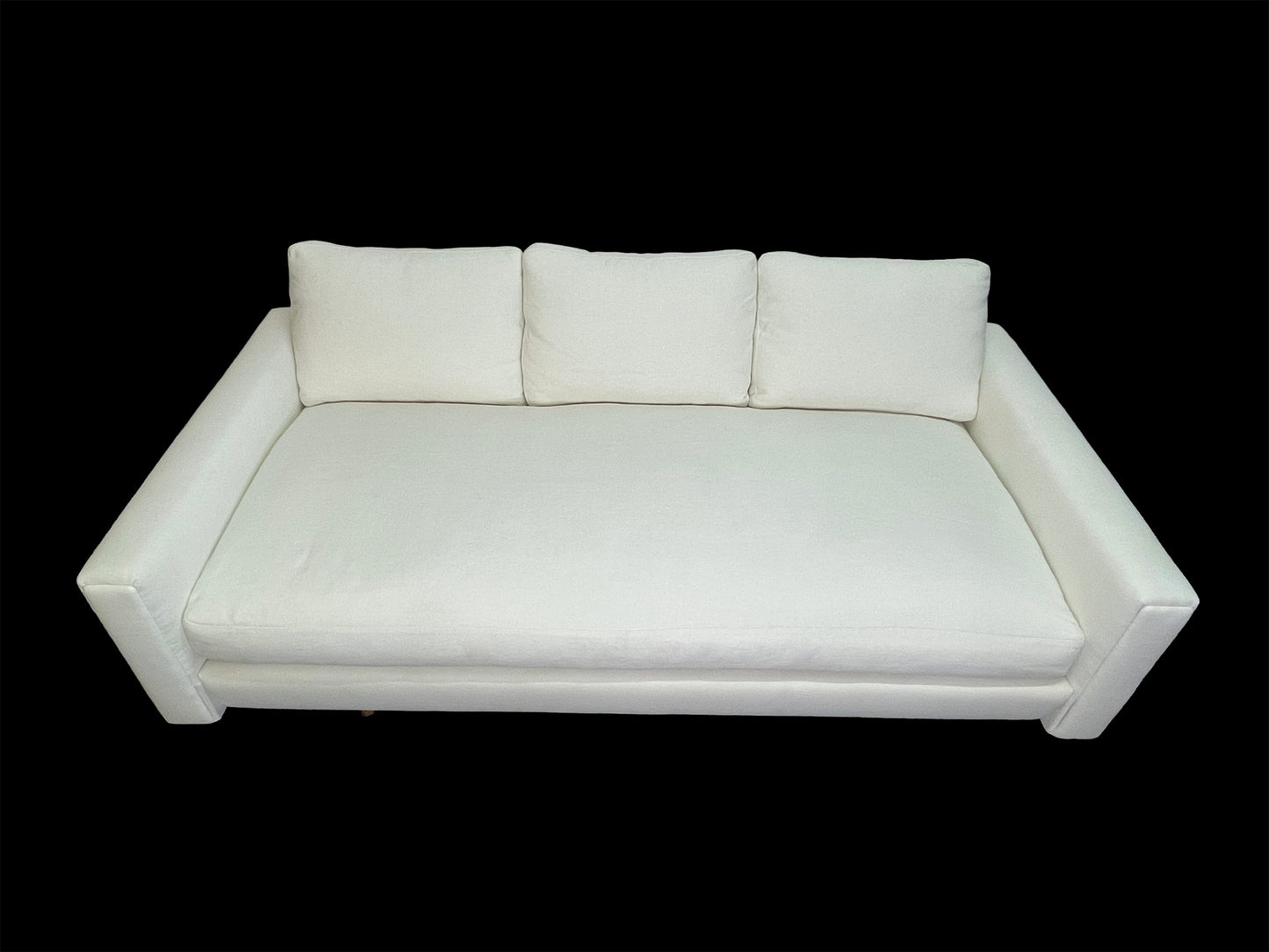 Custom sculptural white upholstered daybed sofa with low-profile modern design and premium cotton upholstery.