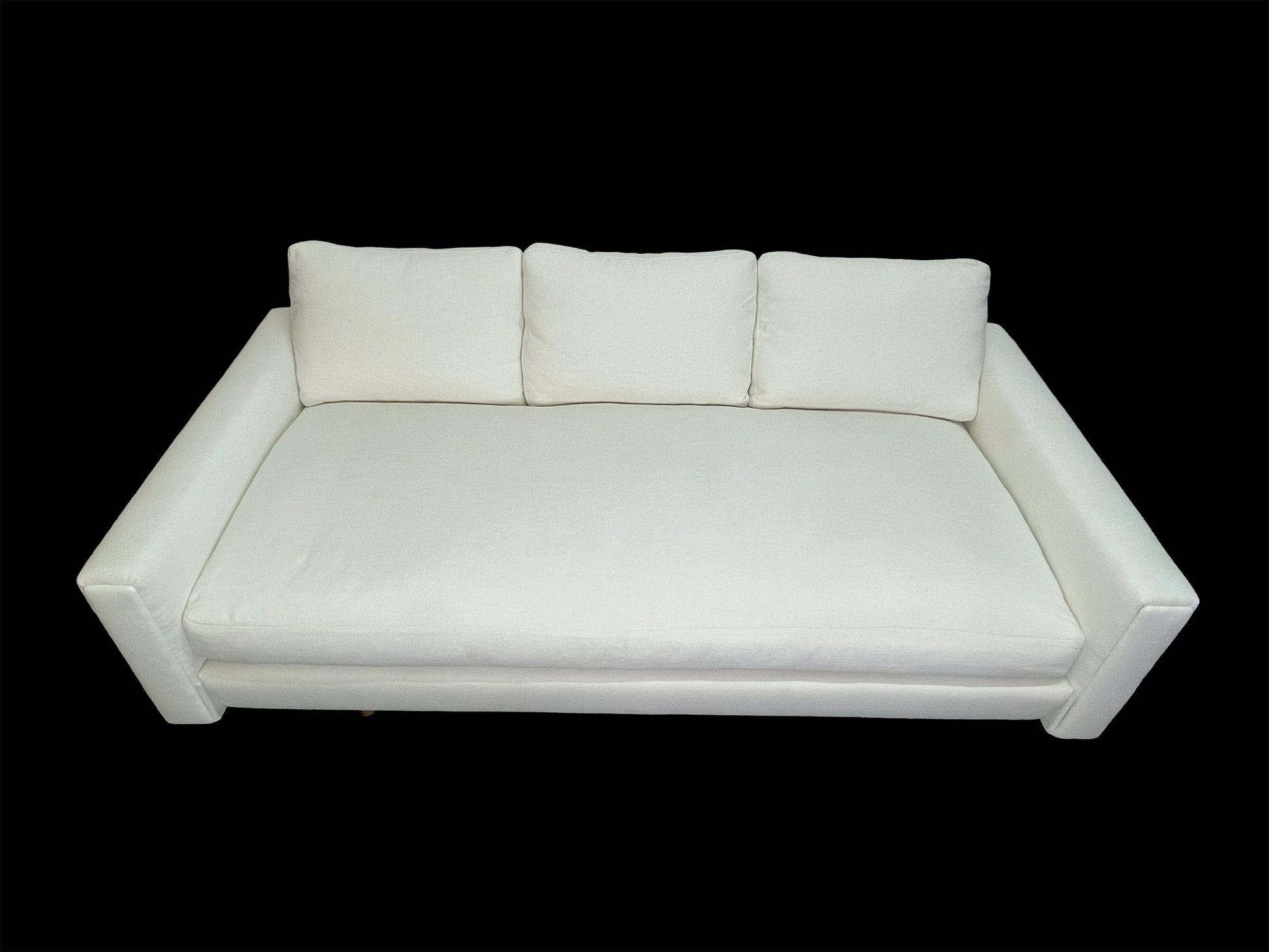 Custom sculptural white upholstered daybed sofa with low-profile modern design and premium cotton upholstery.