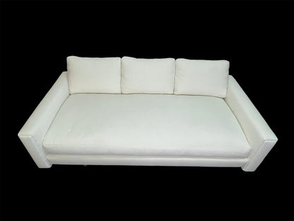 Custom sculptural white upholstered daybed sofa with low-profile modern design and premium cotton upholstery.