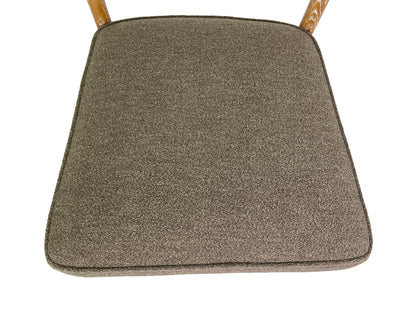 Close-up of brown fabric upholstery on Danish Modern dining chair seat
