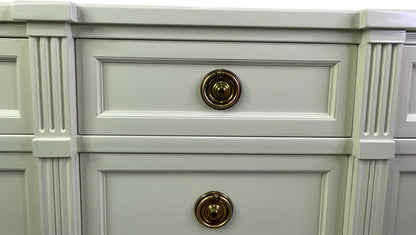 Close-up of brass hardware on American of Martinsville dresser with off-white lacquer center drawers
