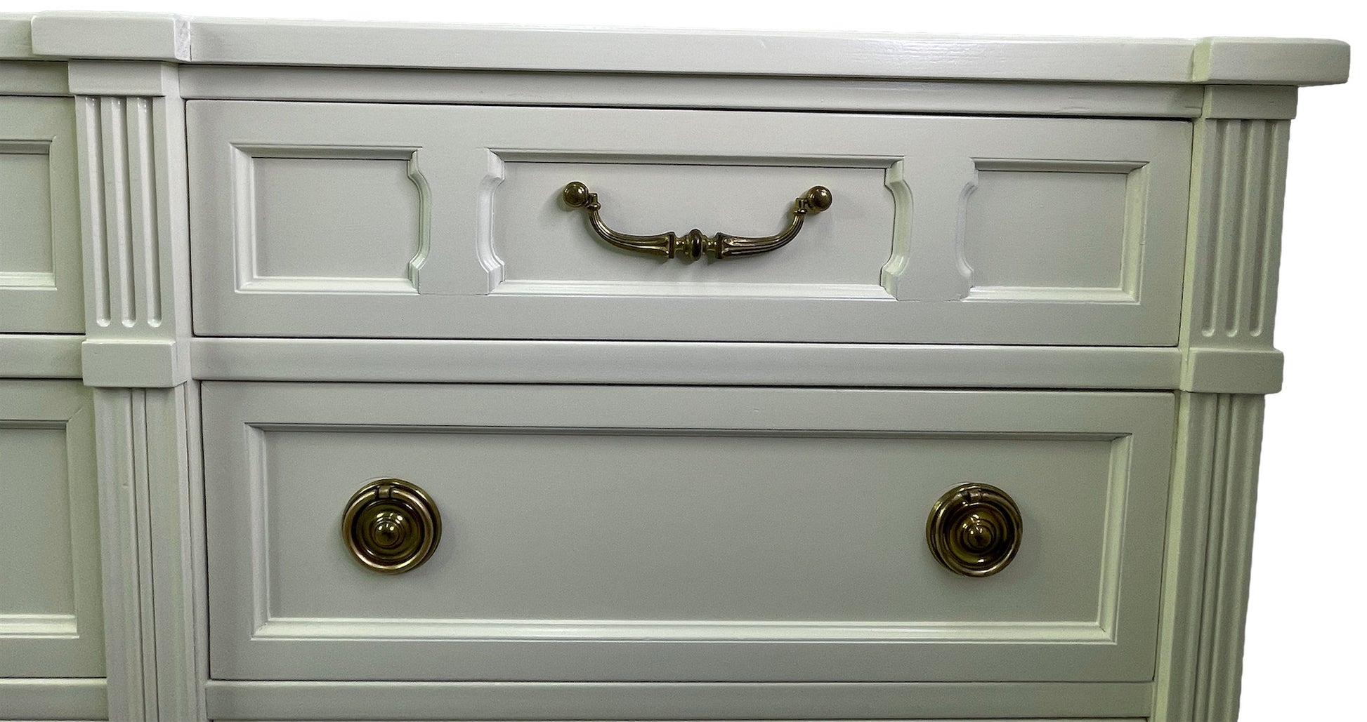 Close-up of brass hardware on American of Martinsville dresser with off-white lacquer top right drawer
