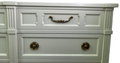 Close-up of brass hardware on American of Martinsville dresser with off-white lacquer top right drawer
