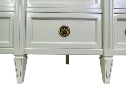 Detail of base and legs on American of Martinsville dresser in off-white lacquer
