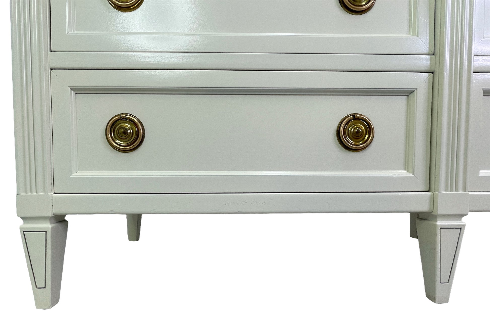 Detail of base and legs on American of Martinsville dresser in off-white lacquer bottom left side
