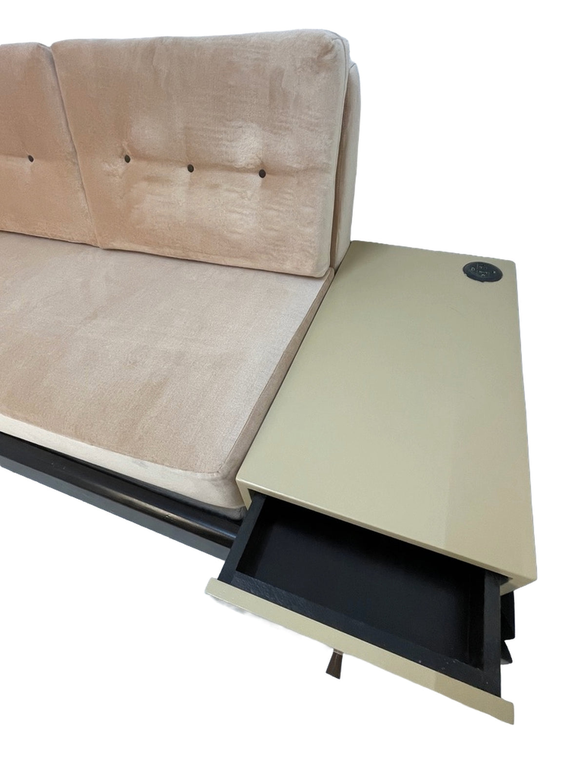 Integrated side table with storage drawer and built-in power outlet on a custom convertible sofa.