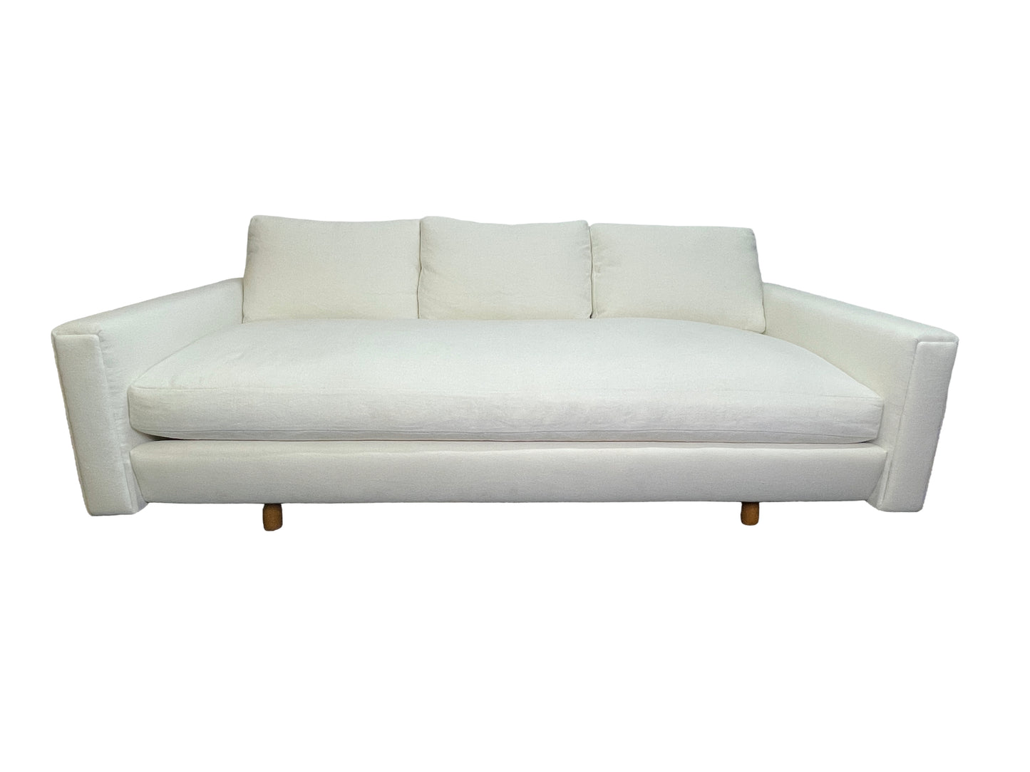 Luxury contemporary white upholstered lounge daybed with deep seating and custom sculptural silhouette.