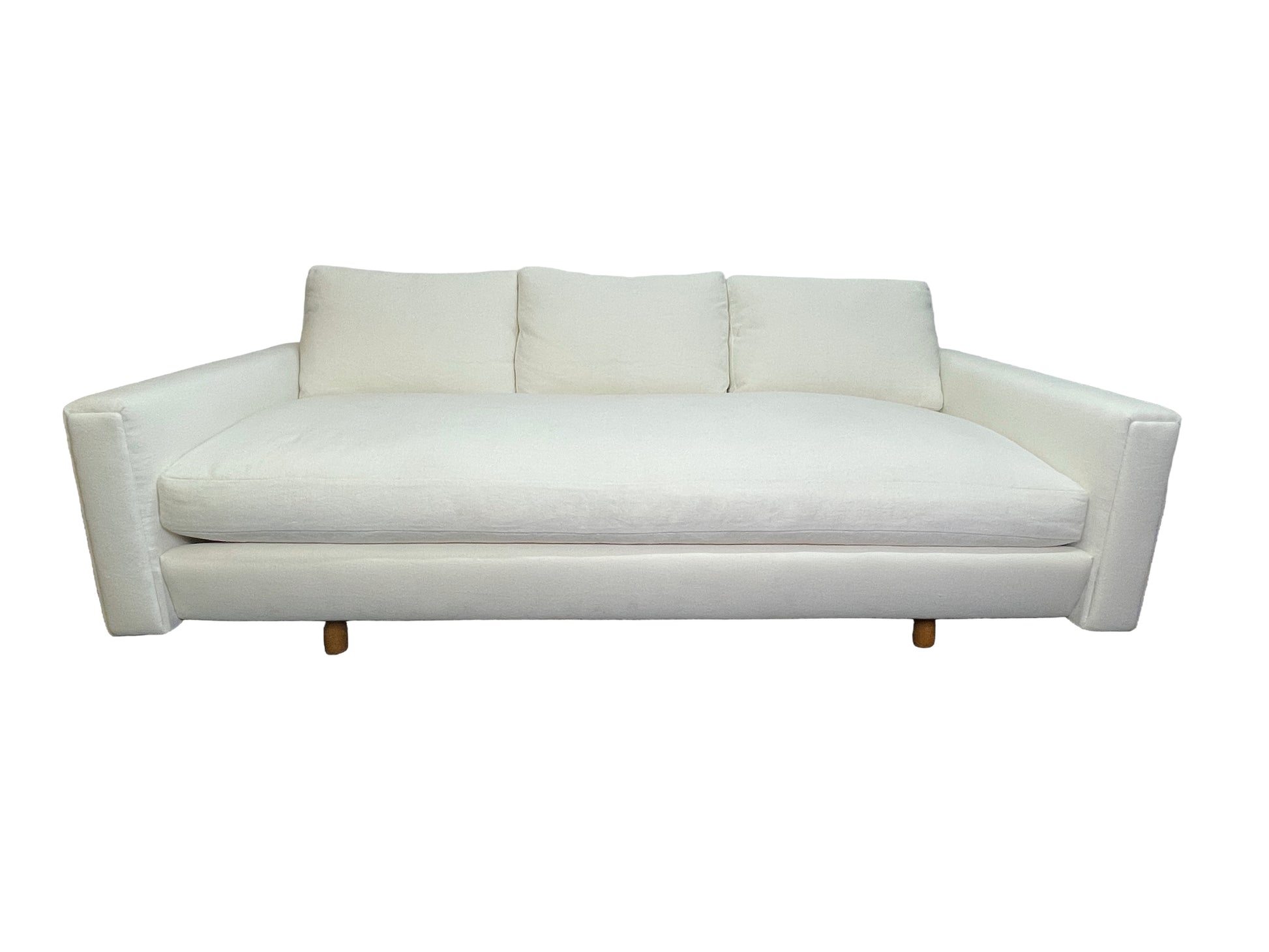 Luxury contemporary white upholstered lounge daybed with deep seating and custom sculptural silhouette.