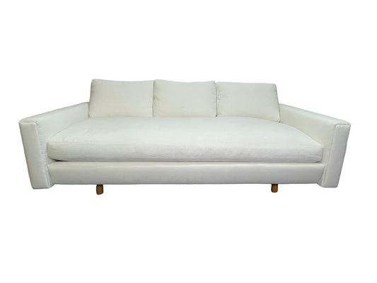Luxury contemporary white upholstered lounge daybed with deep seating and custom sculptural silhouette.