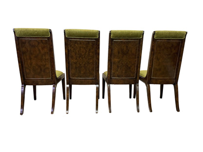 Rear view of four dining chairs with framed burl wood back panels and brass-tone trim