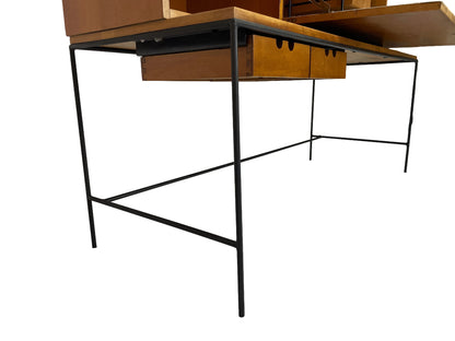 Detail of Paul McCobb Planner Group desk showing minimalist black iron frame, exposed maple drawers, and clean mid-century modern lines.