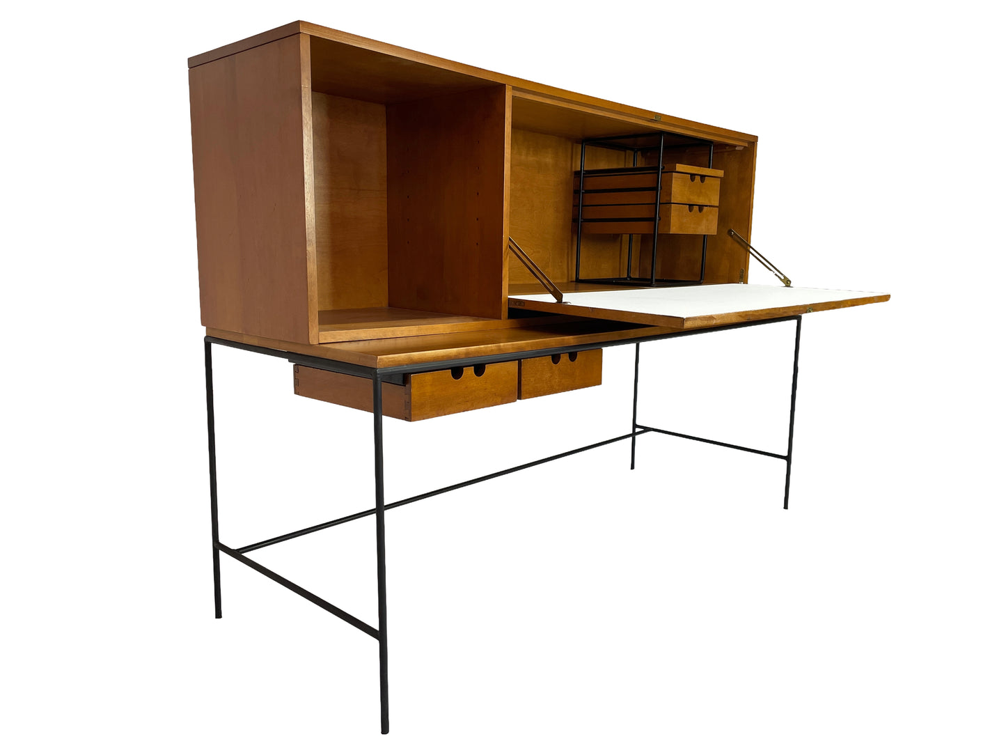 Three-quarter view of a Paul McCobb Planner Group secretary desk in solid maple with black iron base and fold-down work surface, American mid-century modern design, 1950s.