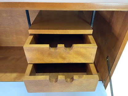 Close-up of maple storage drawers inside Paul McCobb Planner Group secretary desk with minimalist mid-century modern detailing.