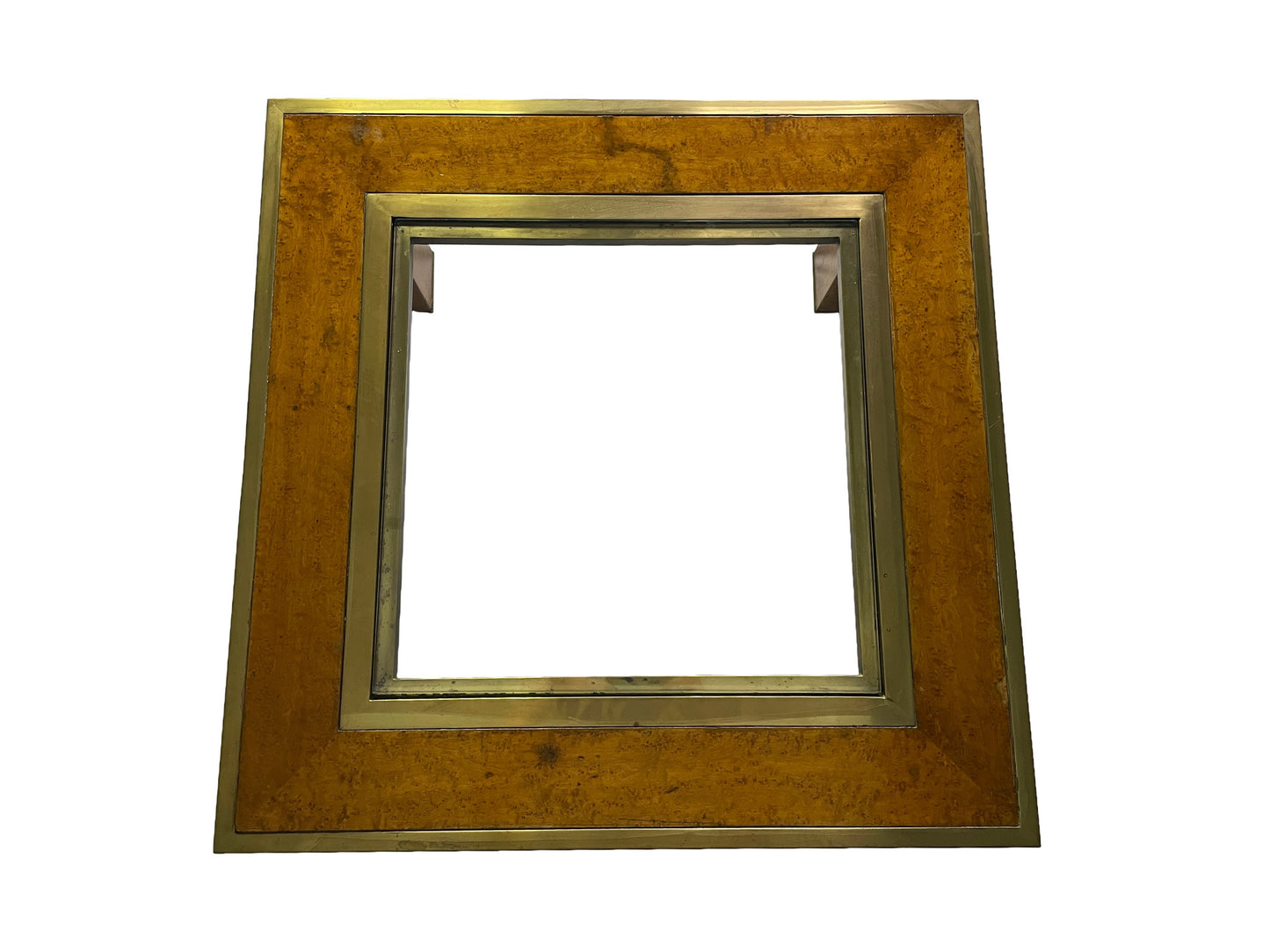 Top view of an olive ash burl coffee table featuring brass framing and a recessed glass center panel.